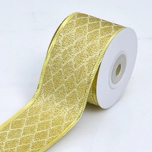 Close-up of golden glitter diamond wired ribbon with decorative wavy edges on a roll