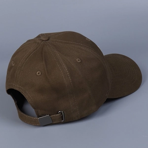 Detail view of the brown baseball cap back with adjustable metal buckle and stitching