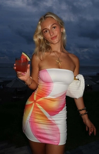 Detail of strapless bodycon mini dress featuring vibrant pink floral print on a white base