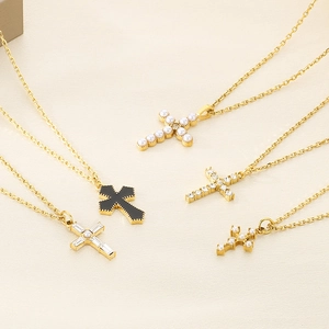 Hip-hop cross necklaces in gold with pearls and cubic zirconia on a beige backdrop
