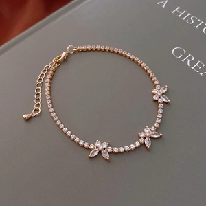 Close-up of gold flower bracelet with zircon stones and adjustable lobster clasp closure