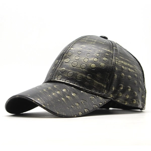 Detail of baseball cap showing black gold PU leather texture and circular embossed pattern