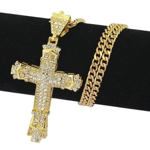 Hip hop style gold iced-out cross pendant with sparkling rhinestones on Cuban link chain