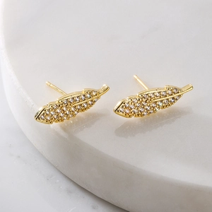 Elegant 18K gold plated leaf earrings with micro-set zircons on white marble
