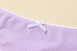 Macro detail of lavender rib-knit thong featuring a white satin bow and delicate texture