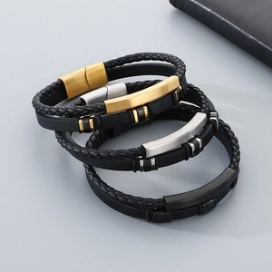 Close-up of triple-layer braided leather bracelets with metallic magnetic clasps