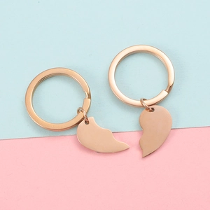 Close-up of split heart-shaped keychain set in rose gold finish with two complementary halves