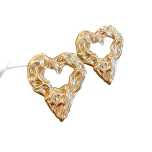Irregular golden heart stud earrings with a unique lava texture and metallic finish for women