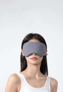Close-up of gray ice silk sleep mask with double-sided cooling feature on model
