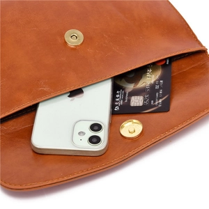 Detail view of the brown leather bag interior showing capacity for smartphone and cards