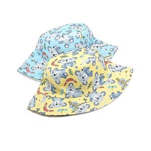 Close-up of cotton bucket hats with cute cartoon koala print and reinforced brim stitching