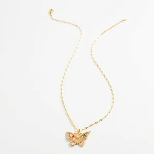 Golden butterfly necklace with sparkling crystals and colored gems on a fine chain