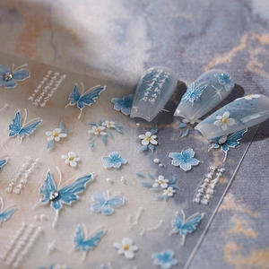 5D embossed butterfly nail stickers with white floral patterns and pearl accents
