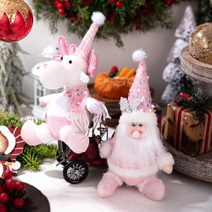 Detail of pink sequin reindeer and Santa plush ornaments in a festive holiday scene