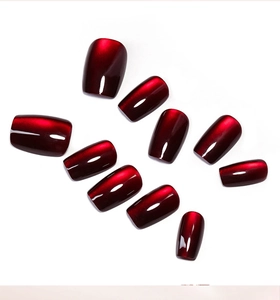 Macro detail of 10-piece dark red cat eye press on nails with glossy gradient finish