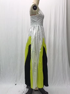 Detail of color-block pleated maxi dress showing white, neon green and black geometric panels