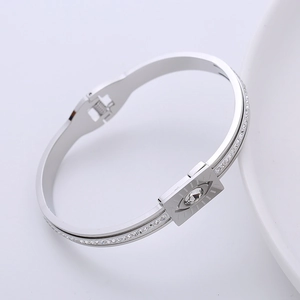 Close-up of a silver devil eye bracelet with pavé rhinestones and spring buckle