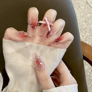Long trapezoidal press-on nails with red-pink gradient, 3D ribbons, and silver rhinestones