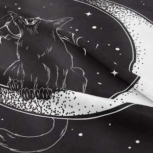 Close-up of black cat and moon print on soft woven tapestry fabric with gothic details