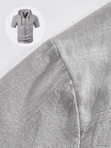 Macro texture of breathable linen fabric on a men's hooded short sleeve grey shirt
