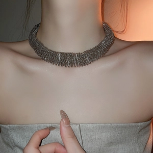 Detail of silver spring textured necklace with industrial spiral design on neck