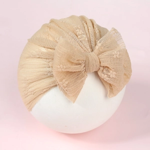 Breathable lace baby turban hat in apricot with a large bow for infant girls