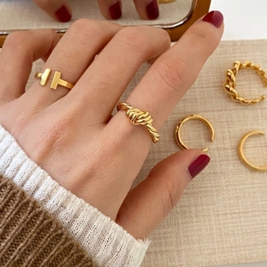 Detailed view of 925 sterling silver knotted ring set in gold finish on fingers