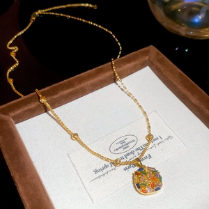 Macro shot of gold-plated necklace with colorful zircon square pendant in luxury jewelry box