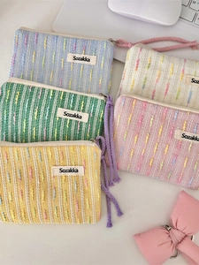 Five assorted colors of small knitted makeup bags for cosmetics and small gadgets