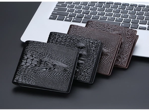 Men's retro crocodile pattern wallets arranged on laptop keyboard for business scene