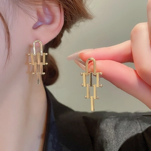 Irregular geometric layered gold earrings with U-shaped clasp and minimalist metallic finish