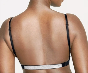 Close-up of sparkling rhinestone back strap on a sexy deep V black push-up bra