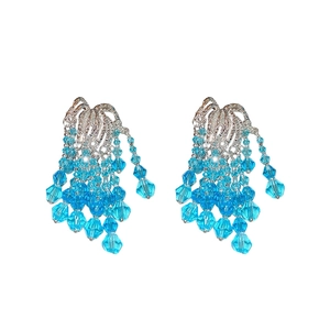 Elegant silver tassel earrings with blue glass beads on a clean white background