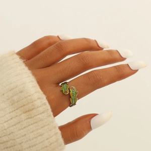 Detail of lizard open ring with yellow-green enamel and red accents on model hand