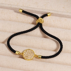 Close-up of adjustable black woven rope bracelet with gold-plated square zircon setting