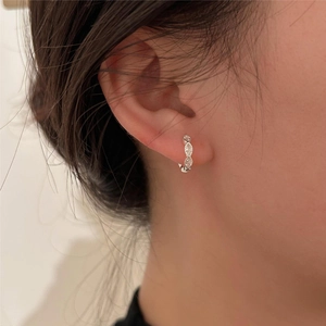 Close-up of S925 sterling silver hoop earrings with marquise-cut zircon on ear