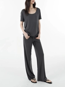 Women's dark gray lounge set featuring short sleeve t-shirt and wide leg drawstring pants
