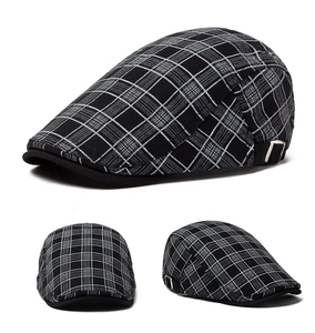 Side view of black and white plaid beret with adjustable buckle and cotton linen texture