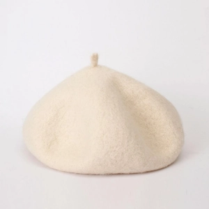 Close-up of wool texture and rounded shape on this beige minimalist beret hat