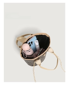 Top view of bucket bag showing interior capacity with phone, umbrella and lipstick