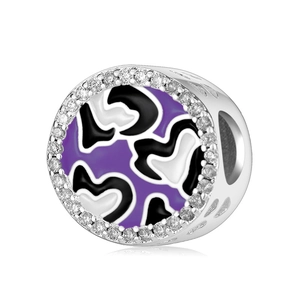 Macro detail of 925 silver charm featuring purple enamel and white zircon heart patterns
