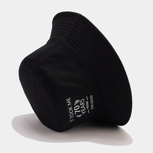 Black cotton bucket hat featuring 70th birthday slogan with a stylish 45-degree angle view
