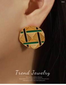 Close-up of geometric round enamel earrings with textured gold patterns and colorful stripes