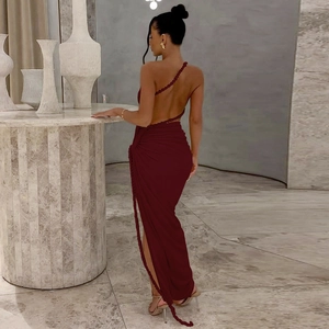 Detail of burgundy one-shoulder dress featuring braided strap and side slit design