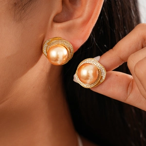 Detailed close-up of vintage flower sweater necklace with gold pearls and sparkling zircons