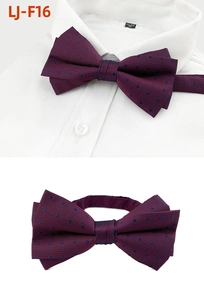 Detailed view of burgundy polka dot bowtie with blue dots on crisp white shirt