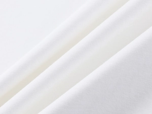 Close-up macro of white textile fabric texture showing dense fine fibers and soft folds