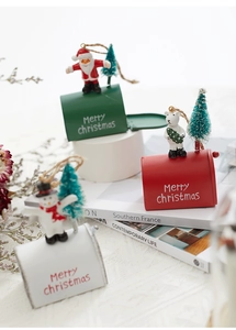 Miniature Christmas mailboxes in red, green, and white with Santa and snowman figurines