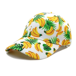 Close-up of fabric twill texture on white baseball cap with banana and tropical leaf print