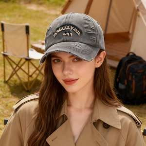 Distressed dark gray baseball cap with AUTUMN embroidery shown in outdoor camping setting